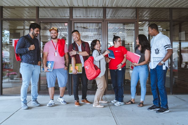 a group of student standing in front of campus building