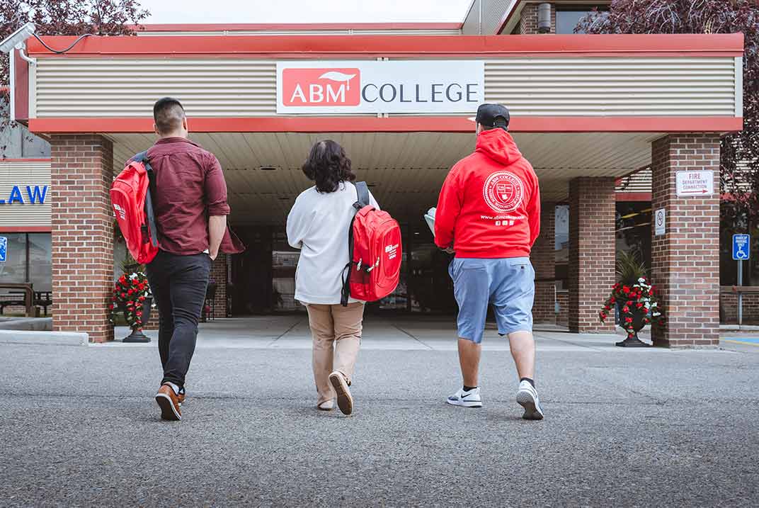 a group of students walking into the campus building