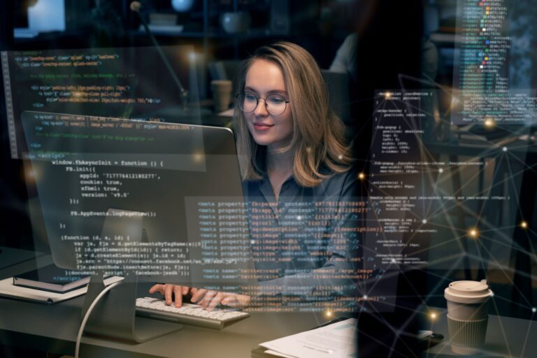 Woman coding on a computer focused on the screen displaying code for web development