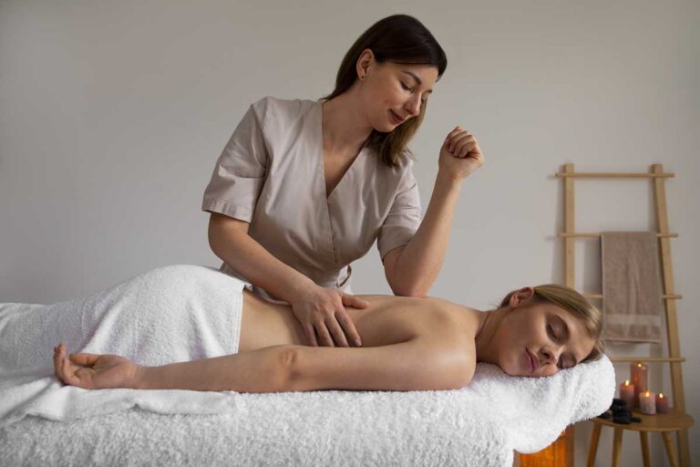 Massage Therapy: 6 Reasons to Relax - woman getting back massage from female masseur