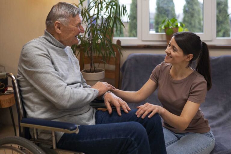 A man in a wheelchair receives support from an personal support worker