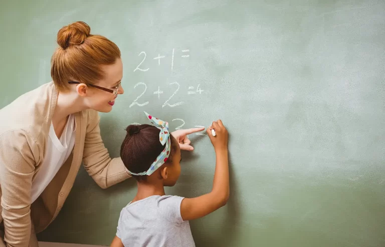 early childhood assistant helping a child in solving math