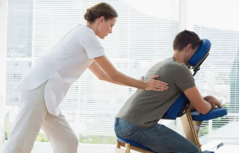 massage therapy diploma graduate stretching a man's back