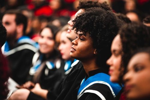 a group of students sitting in a row in an event