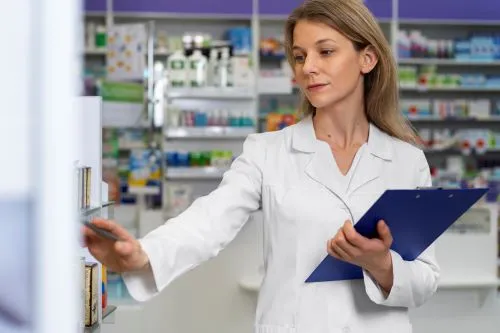 Female pharmacy assistant looking for details 