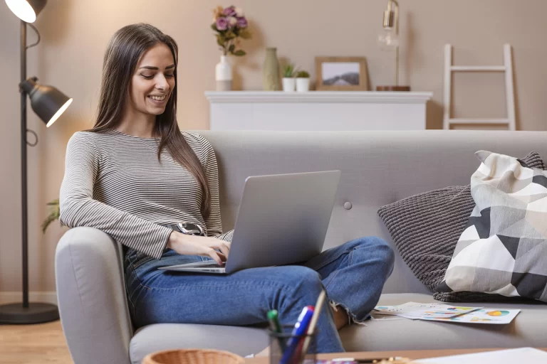 woman working comfortably at home on her couch